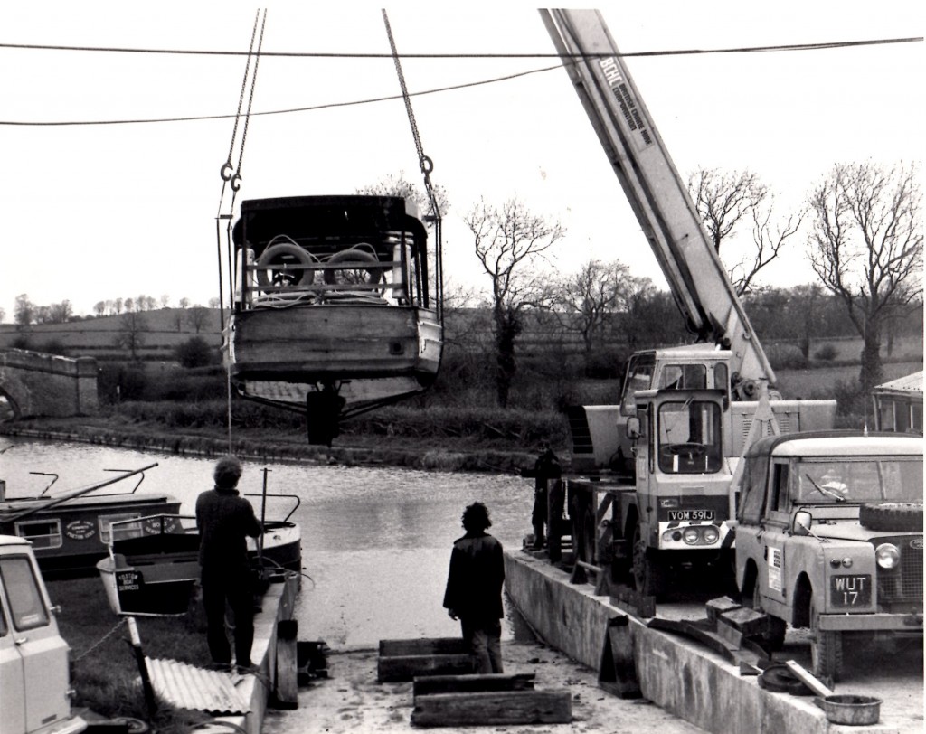 A narrowboat being craned out for boat services work